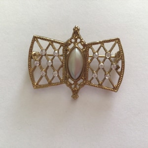 Vintage  1928Co Etruscan Style Brooch with Lattice Work Design and Sapphire Glass Navette Centerstone.