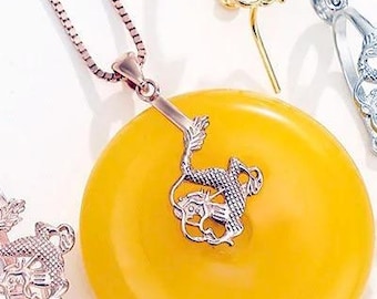 May include: A rose gold chain necklace with a circular yellow pendant and a dragon-shaped bail, accompanied by three additional dragon-shaped bails in rose gold, yellow gold, and silver tones. The text ClareAccessories is visible at the bottom.