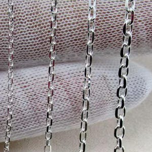 May include: Six silver-toned metal chains of varying thicknesses arranged vertically side by side. Each chain features a series of interconnected oval-shaped links, progressing from a very fine, delicate gauge on the left to a thicker, more prominent link style on the right.
