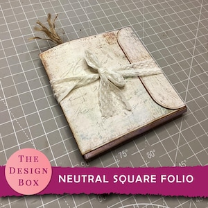 May include: A square folio with a neutral design, featuring a cream-coloured cover with script-like text and a lace ribbon closure. The folio is labelled "NEUTRAL SQUARE FOLIO" and has a decorative tassel.