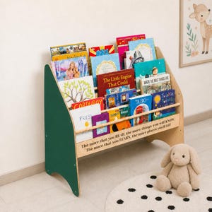 May include: A wooden children's bookshelf with dark green side panels and natural wood shelves. The front features the text: The more that you READ, the more things you will KNOW. The more that you LEARN, the more places you'll GO!