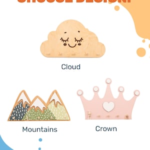 May include: Three wooden wall hooks in the shapes of a cloud, mountains, and a crown. The cloud has a smiling face with eyelashes. The mountains are green and brown with white snow peaks. The crown is pink with a white heart in the center.  Choose Design: is written at the top of the image.