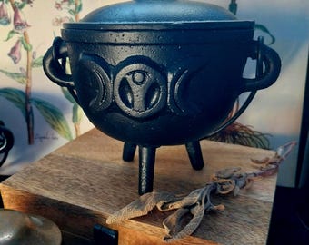 black cast iron cauldron with triple moon motif
