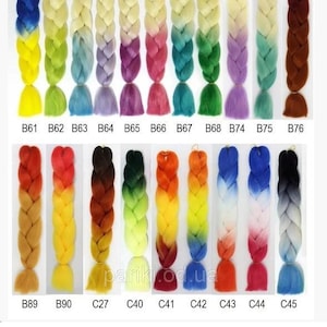 May include: A selection of ombre braiding hair in various colors, including blue, green, yellow, orange, red, and brown. The hair is arranged in rows with labels indicating the color codes: B61, B62, B63, B64, B65, B66, B67, B68, B74, B75, B76, B89, B90, C27, C40, C41, C42, C43, C44, and C45. The text "MORE COLORS" is visible at the bottom of the image.
