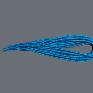 May include: A bundle of teal blue synthetic dreadlocks.