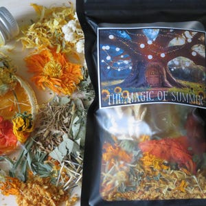 May include: A black bag with a label that reads "THE MAGIC OF SUMMER" next to dried orange slices, yellow flowers, and herbs. A small glass bottle with a silver lid is also visible. The image has a natural, earthy aesthetic.