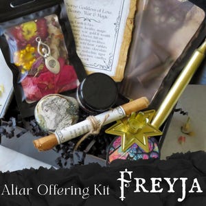 May include: An altar offering kit in a black box, containing a variety of items. Includes a bag of dried flowers, a pendant, a small jar, a scroll, a candle, and a star-shaped holder. The text "FREYJA" and "Altar Offering Kit" are visible.