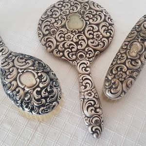 Сhic vintage Vanity Set Three Piece handheld mirror and Brushes. Antique Versilbert Repousse alpaca silver plate