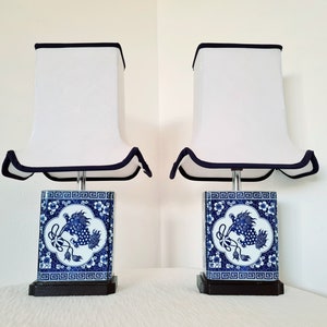Vintage a pair of beautiful Chinese lamps with ceramic bases and cotton shades
