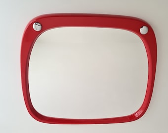 May include: A red plastic framed mirror with rounded edges and silver accents.