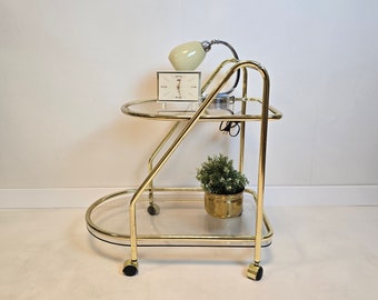 Vintage Hollywood Regency Modern brass trolley table with glass. Mid Century wheels Bar Cart