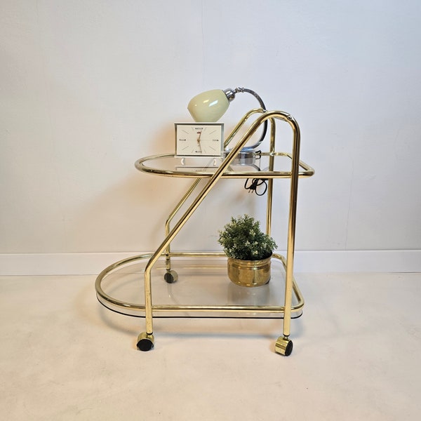 Vintage Hollywood Regency Modern brass trolley table with glass. Mid Century wheels Bar Cart