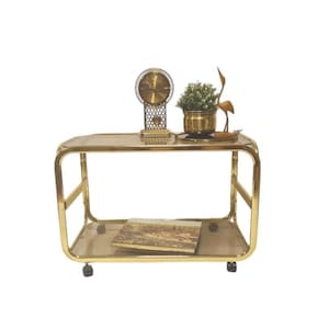 Vintage Hollywood Regency big brass Table on wheels and smoked glass 1980s
