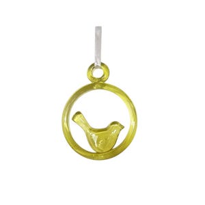 May include: A yellow glass charm with a bird inside a circle. The charm is attached to a silver bail.