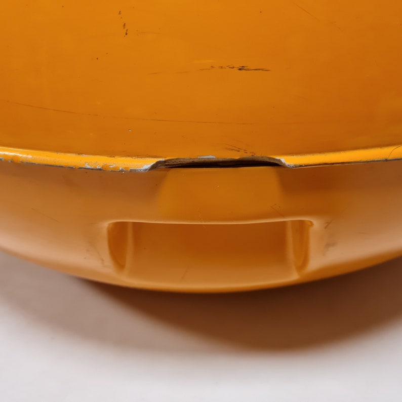 May include: Orange enamel cast iron pot with a small chip on the rim.
