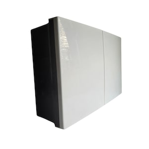 May include: A white cabinet with a black side panel. The cabinet has a glossy finish and a simple, modern design. The cabinet appears to have three doors or panels on the front.