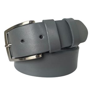 May include: A grey leather belt with a silver buckle. The belt is folded in half, showing the buckle and the leather strap.