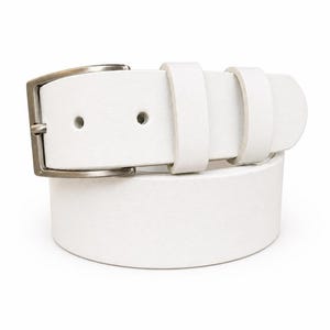 May include: A white leather belt with a silver-colored buckle. The belt has two belt loops and two holes for the buckle. The belt is a solid white color and is made of leather.