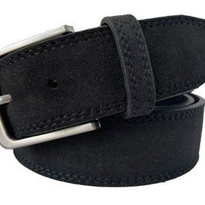 May include: A black suede belt with a silver buckle. The belt has a stitched edge.