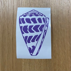 May include: A purple conch shell sticker with a detailed design. The shell is a light purple color with a darker purple pattern. The sticker is on a white background.
