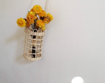 an asymmetrical pine needle basket with a Rosetta stone base Can hang two directions or sit on table. coiled basket Listening