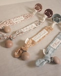 Personalized cotton gauze pacifier clip: embroidered name product logo