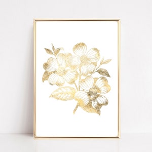 May include: Gold foil print of a floral bouquet with white flowers and leaves on a white background. The print is framed in a gold frame.