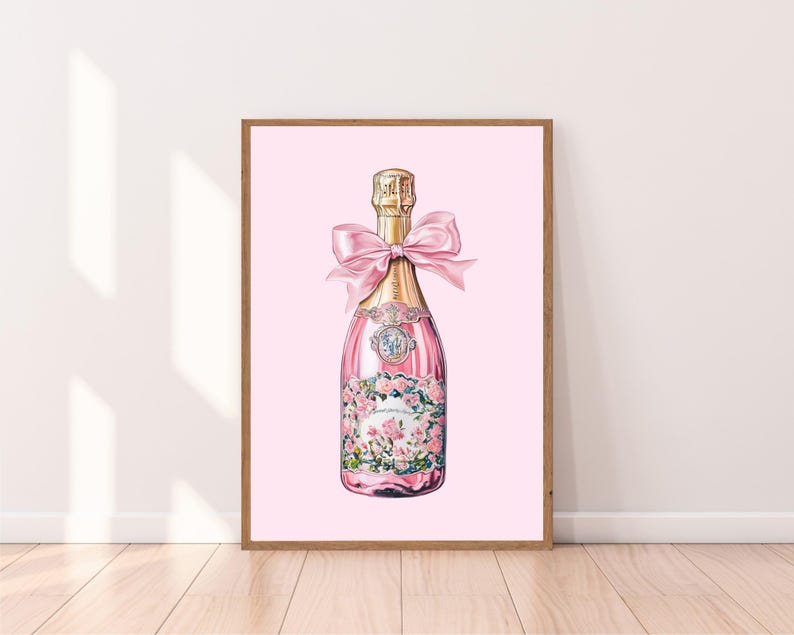 May include: A pink champagne bottle with a gold label and a pink ribbon bow. The bottle is illustrated with pink flowers and green leaves.