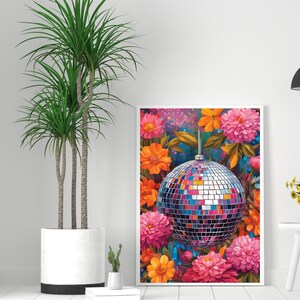 May include: A framed print of a colorful floral arrangement with a disco ball in the center. The flowers are pink, orange, and yellow, and the disco ball is silver with mirrored tiles.