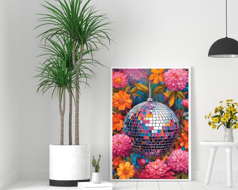 May include: A framed print of a colorful floral arrangement with a disco ball in the center. The flowers are pink, orange, and yellow, and the disco ball is silver with mirrored tiles.