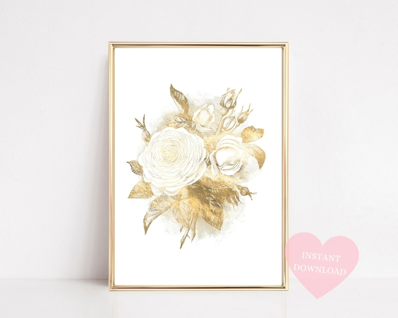 May include: A framed art print featuring a watercolor illustration of white roses and gold-colored leaves. The artwork is set against a white background and framed in a gold-colored frame. The print has a soft, elegant aesthetic.