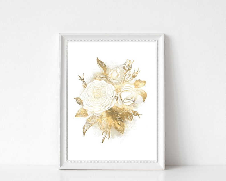 May include: A framed art print featuring a watercolor illustration of white roses and gold leaves. The floral arrangement is set against a white background, with a white frame. The artwork has a soft, elegant aesthetic.