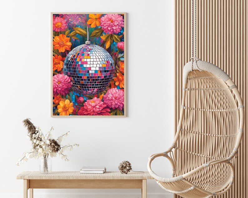 May include: A silver disco ball surrounded by pink, orange, and yellow flowers. The flowers are in bloom and have a vibrant, colorful appearance.