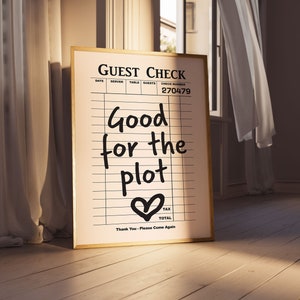May include: A framed print with a guest check design. The print says "Good for the plot" with a heart symbol at the bottom. The check number is 270479.