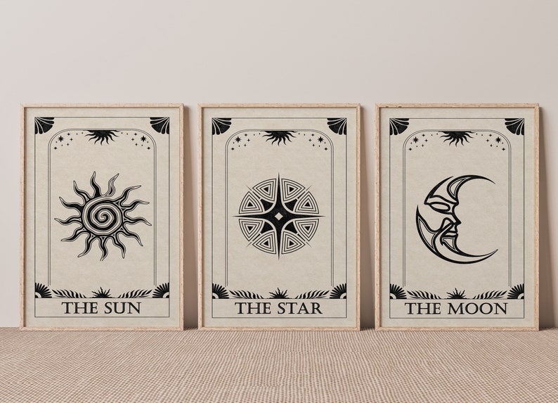 May include: Three framed prints with black and white illustrations of the sun, star, and moon. The prints have a beige background and the text "THE SUN", "THE STAR", and "THE MOON" at the bottom.