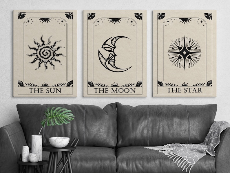 May include: Three black and white tarot cards with illustrations of the sun, moon, and star. The cards have a beige background and the text "The Sun", "The Moon", and "The Star" printed below the illustrations.