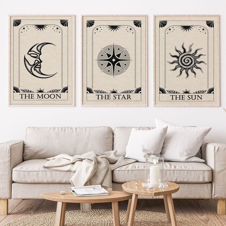 May include: Three black and white tarot card prints with a beige background. The cards are titled "The Moon", "The Star", and "The Sun". Each card features a stylized image of the moon, a star, and the sun.