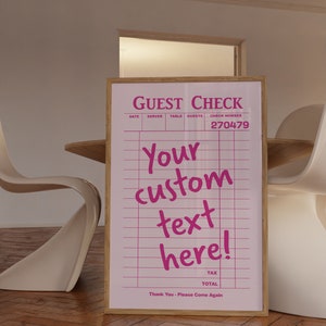 May include: A pink and white guest check with the text "GUEST CHECK" and "Your custom text here!" on a wooden frame. The check number is 270479.