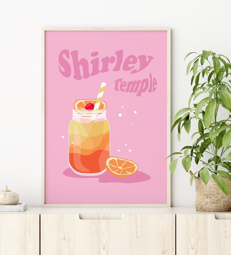 May include: A pink printable poster with the text "Shirley Temple" in a retro font. The poster features a cartoon illustration of a mason jar filled with a layered orange and yellow drink with a cherry and orange slice on top. A straw is sticking out of the drink.