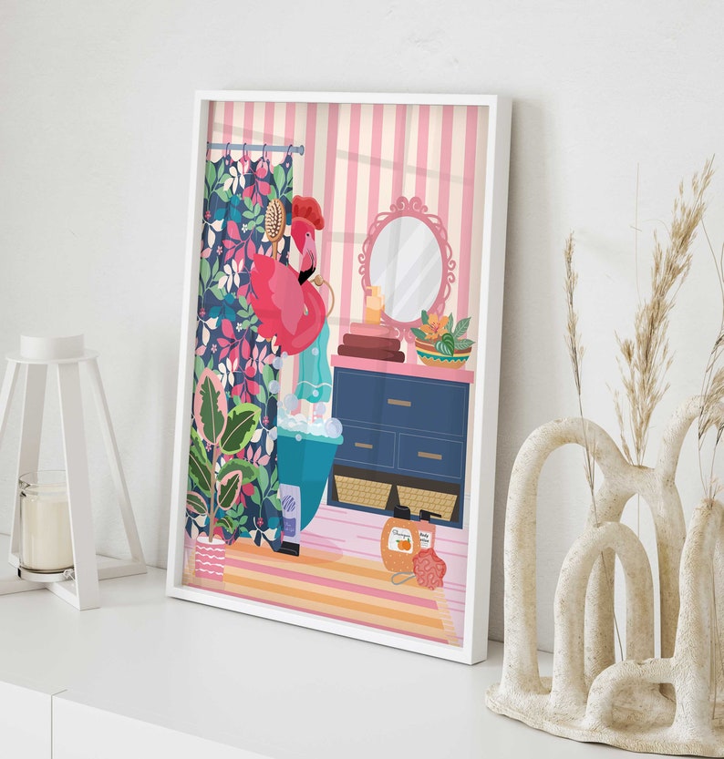 May include: A pink flamingo taking a bath in a blue bathtub with bubbles. The bathroom has a floral shower curtain, a blue vanity with drawers, and a round mirror. There are towels, a bowl of fruit, and a bottle of shampoo on the vanity.
