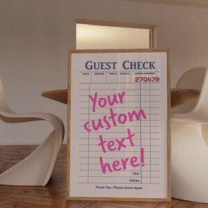 May include: A white guest check with a wooden frame. The check has a blue header that says "GUEST CHECK" and includes columns for date, server, table, guests, and check number. The check number is 270479. The text "Your custom text here!" is written in pink cursive.