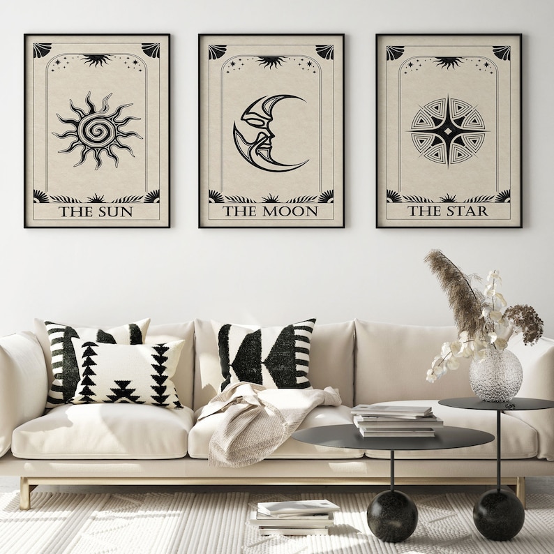 May include: Three black and white tarot card prints with beige backgrounds. The prints feature the Sun, Moon, and Star symbols with the corresponding names below each image.