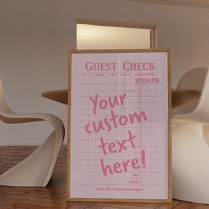 May include: A pink and white guest check with the text "GUEST CHECK" and "Your custom text here!" in pink. The check number is 270479.
