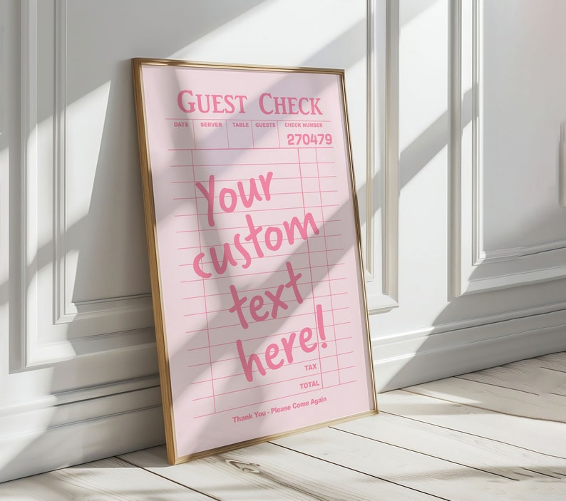 May include: A pink guest check with a gold frame. The check has a grid pattern and the text "GUEST CHECK", "DATE", "SERVER", "TABLE", "GUESTS", "CHECK NUMBER", "270479", "Your custom text here!", "TAX", "TOTAL", and "Thank You - Please Come Again".