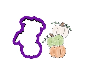 May include: A purple pumpkin-shaped cookie cutter next to a stack of three pumpkins in shades of orange, green, and white, with green vines. The pumpkins are hand-drawn with a watercolor effect, perfect for fall baking.