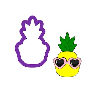 May include: A purple pineapple cookie cutter with a yellow pineapple wearing pink heart-shaped sunglasses.