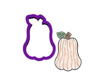 May include: A purple cookie cutter in the shape of a pumpkin with a brown stem and green leaf. Next to the cutter is a hand-drawn illustration of a beige pumpkin with a brown stem and green leaf.