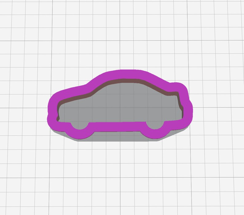 May include: Purple plastic cookie cutter shaped like a car.