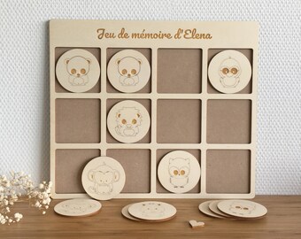 May include: Wooden memory game with a light wood frame and 9 squares. The squares have images of animals, including an owl, a monkey, a panda, and a lion. The game is labeled "Jeu de mémoire d'Elena".
