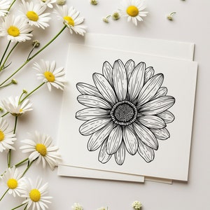 May include: A black and white line drawing of a daisy flower on a white card.